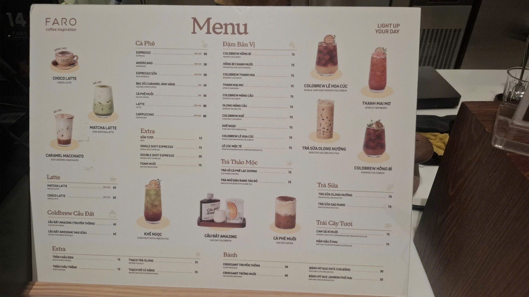 A menu board from a coffee shop named 'FARO', featuring various beverages such as espresso-based drinks and specialty lattes, along with some non-alco