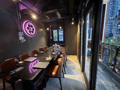 The image depicts a modern interior of what appears to be an upscale restaurant or dining area in Thao Dien, Saigon. The space features dark tones wit