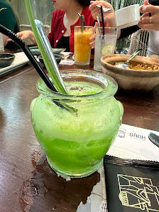 A green-colored drink served in a glass jar on a table at Thao Dien, Saigon.