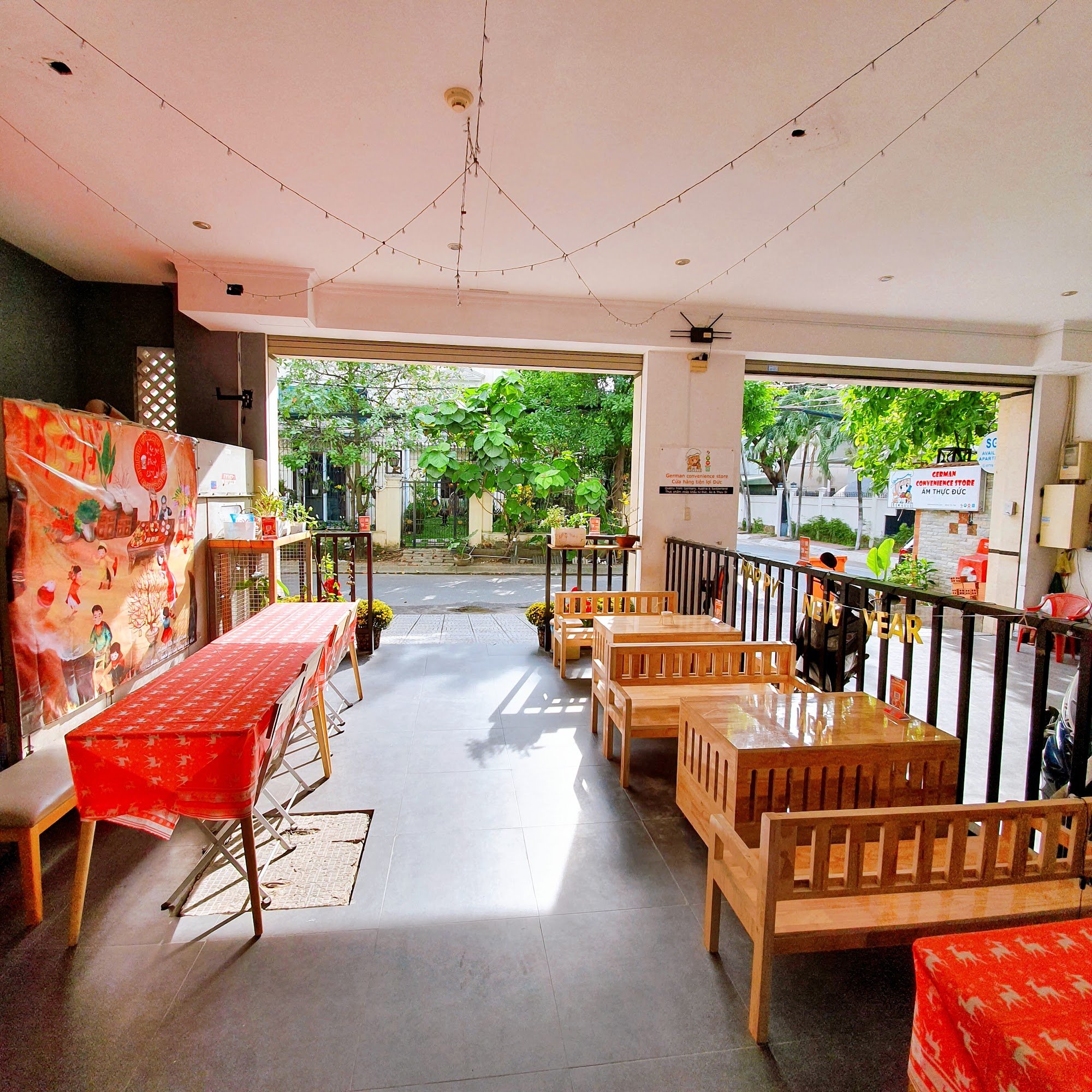 The image shows an interior view of a casual dining establishment in Thao Dien, Saigon. The space is well-lit with natural light streaming through the