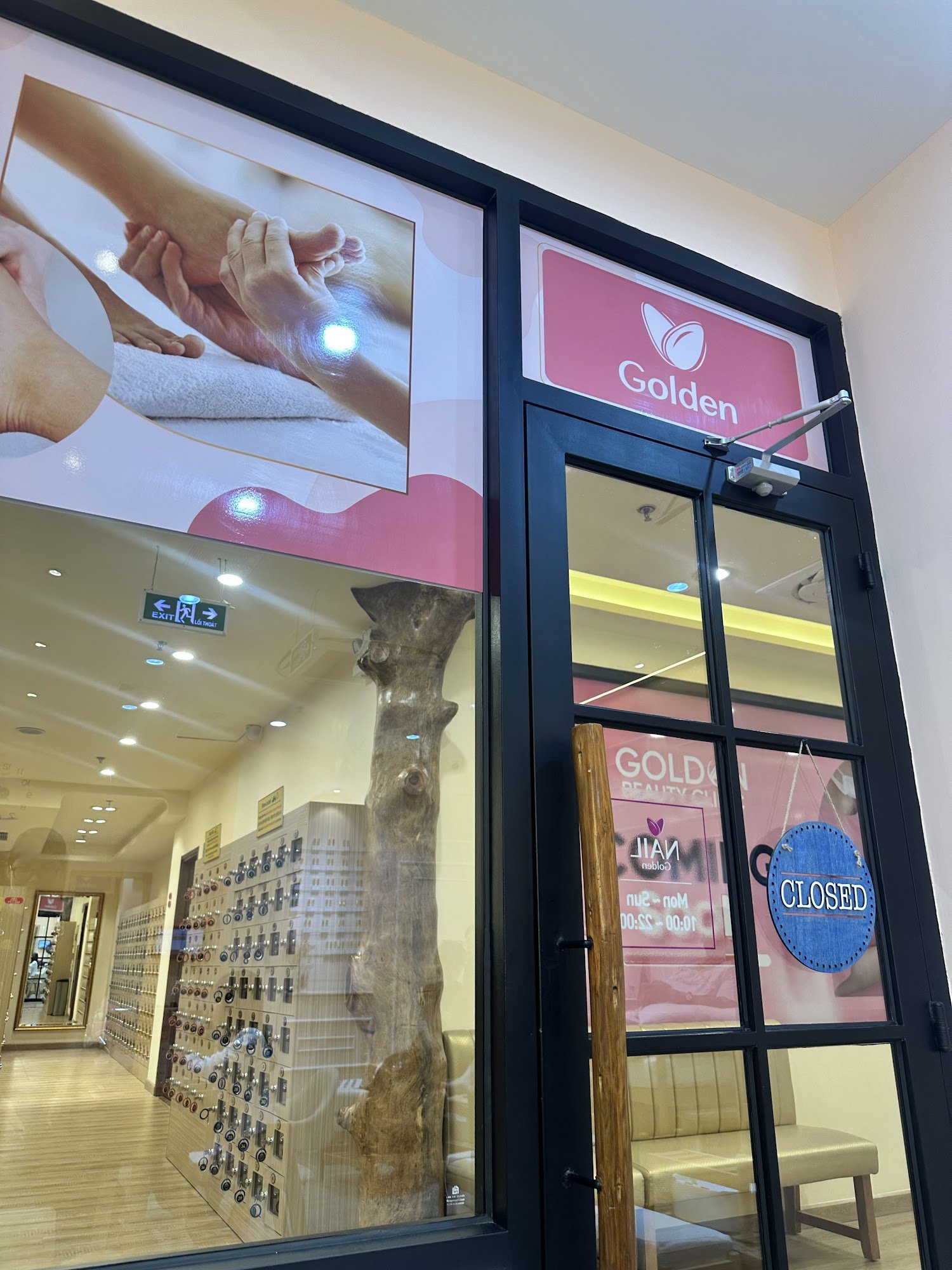 The image shows an interior view of a wellness or spa establishment named 'Golden'. The entrance is visible with large glass windows displaying the br