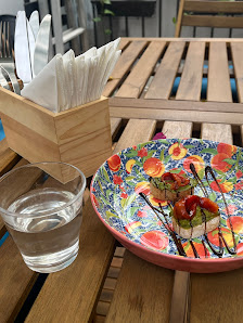 The image shows a colorful plate of food on a wooden table in what appears to be an outdoor dining area at Thao Dien, Saigon.
