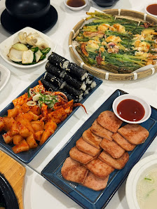 A selection of Korean dishes including kimchi, bulgogi, and various side dishes