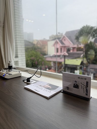 The image shows a modern interior setting of what appears to be an office or lounge area with large windows overlooking the outside scenery, which inc
