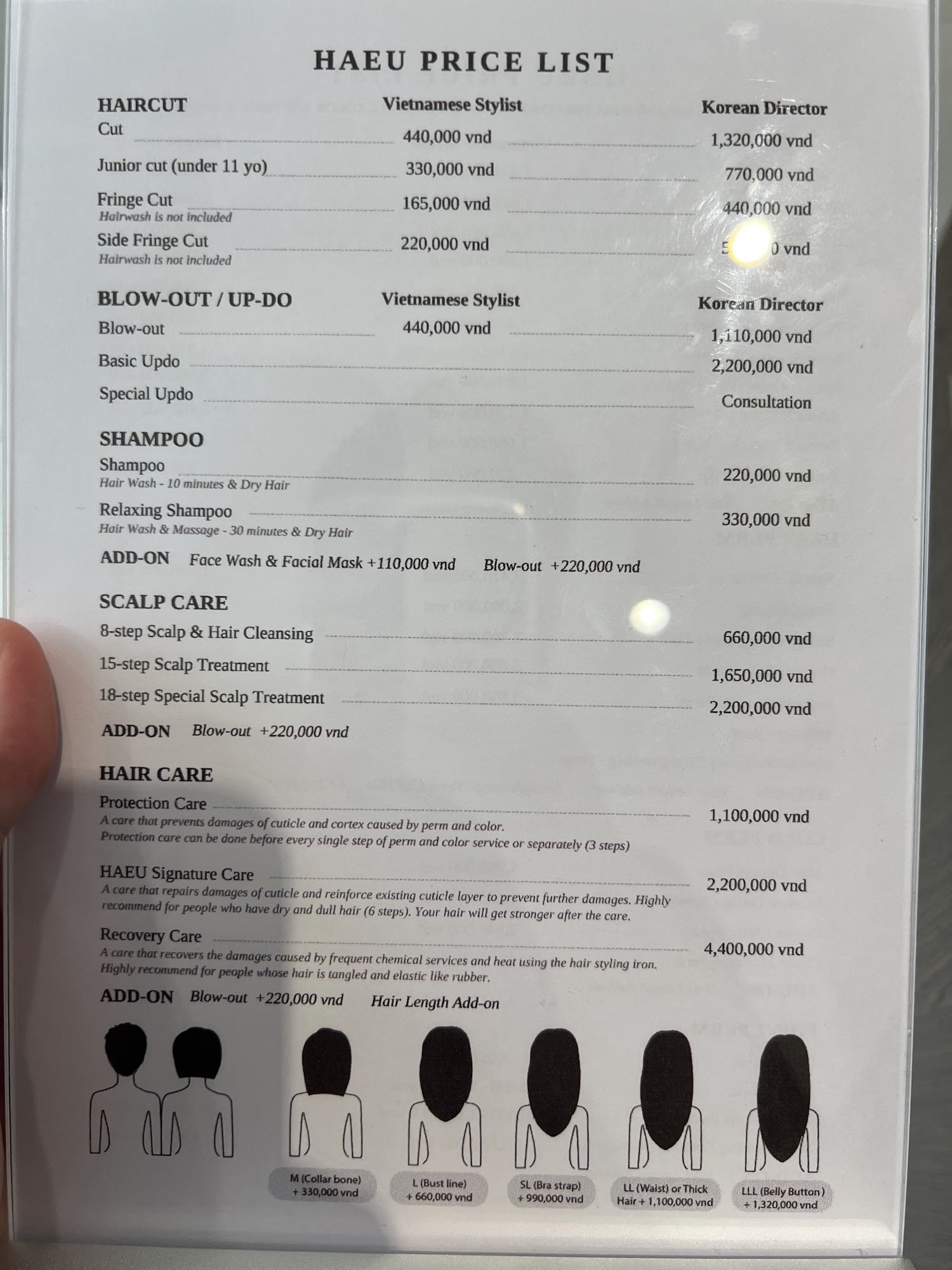 A price list for haircuts and related services at a Vietnamese stylist's establishment.