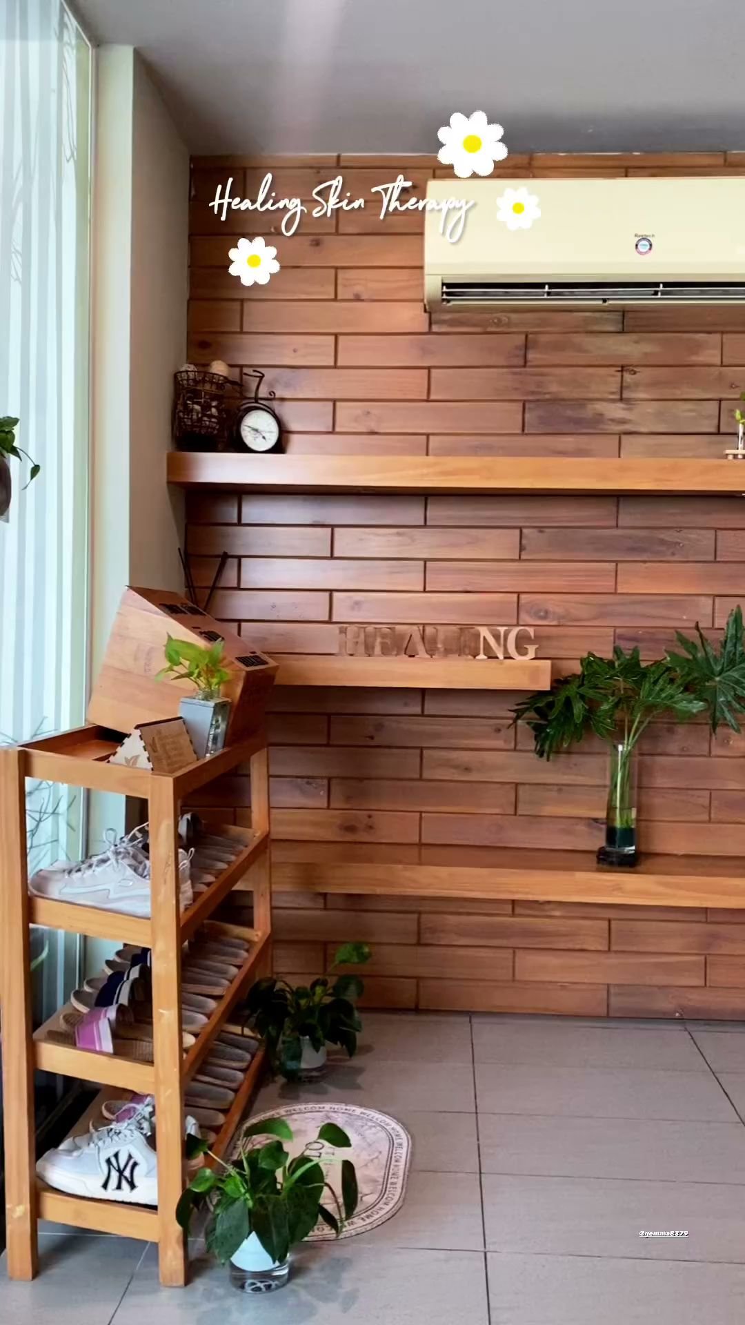 This image depicts an interior space that appears to be a personal living area or studio apartment with wooden paneling on the walls and floor, creati