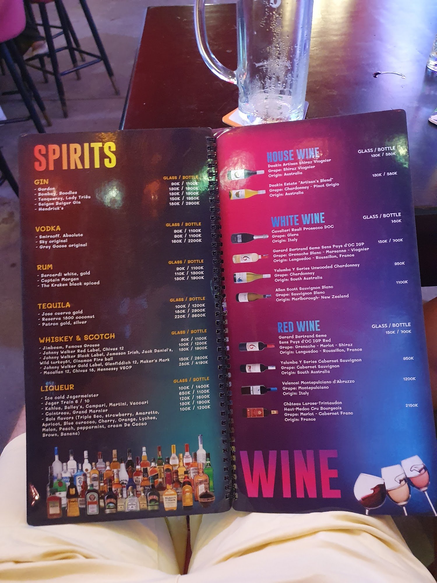 The image shows a menu from Thao Dien, Saigon featuring various types of spirits and wines with their respective brands listed alongside prices in Vie