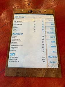 A menu board from a venue in Thao Dien, Saigon displaying various food and drink options such as beer on tap, cider, salad, breakfast items like omele