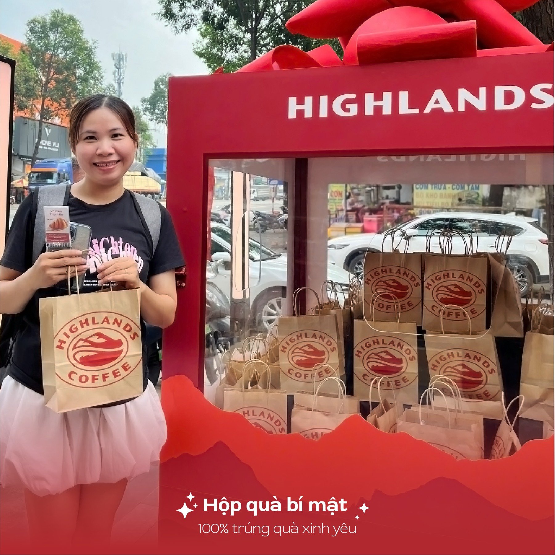 A woman is standing in front of a coffee shop named 'Highlands Coffee'. She holds several takeaway bags from the store and appears to be promoting or
