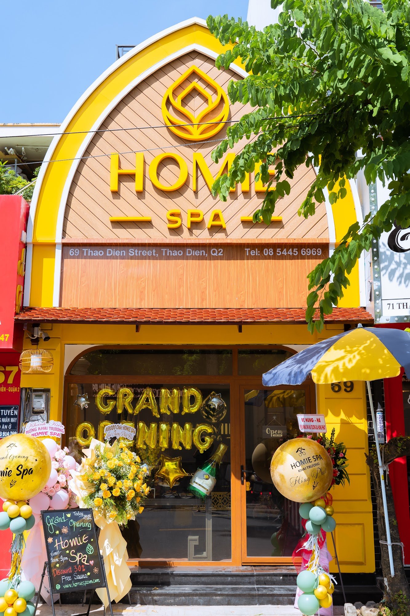 The image shows an exterior view of a spa named 'HOME SPA' located at Thao Dien Street in Saigon, Vietnam.