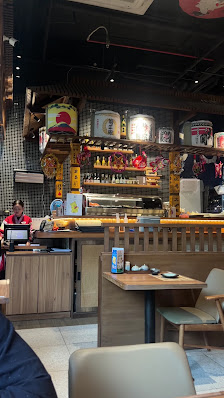 The image shows an interior view of a restaurant or food establishment in Thao Dien, Saigon. The counter area is visible with various items on display