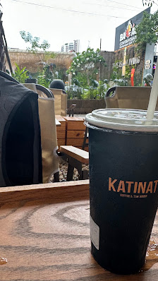 A beverage cup from Katina Cafe is placed on a wooden tray outside of the cafe in Thao Dien, Saigon.