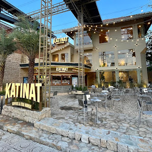 The image shows an exterior view of a restaurant named 'KATINAT' located in Thao Dien, Saigon. The establishment has outdoor seating with tables and c