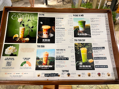 A menu board displaying various beverage options including smoothies and shakes in a cafe setting.