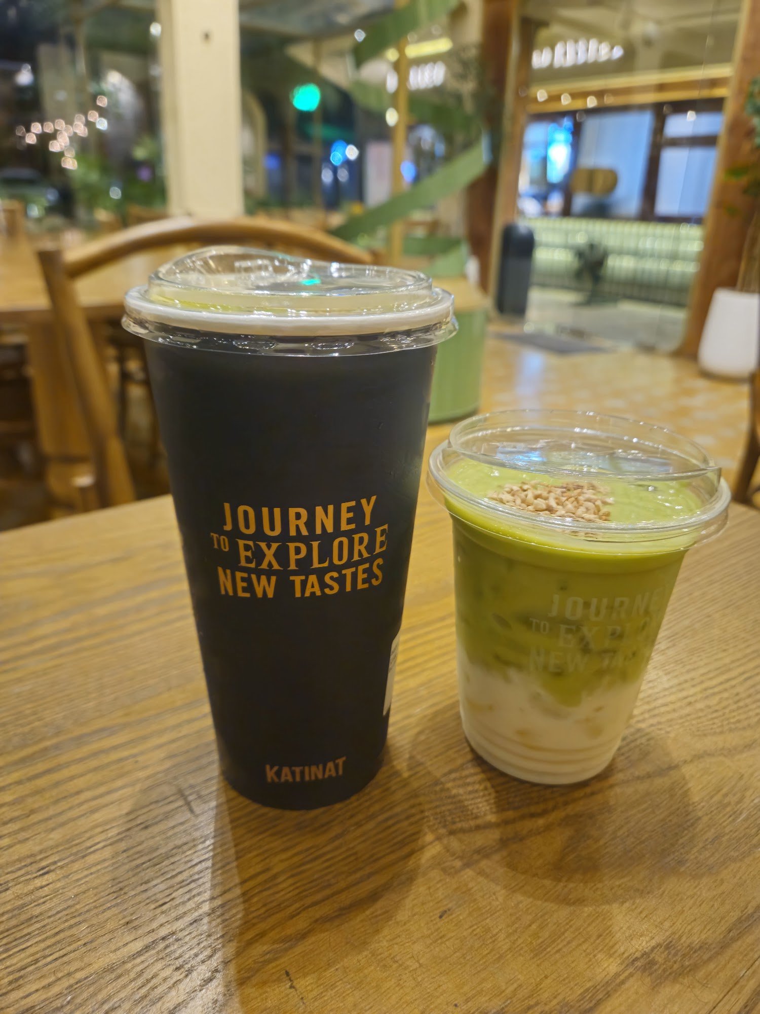 Two beverages are placed on a wooden table in what appears to be an indoor setting of Thao Dien, Saigon.