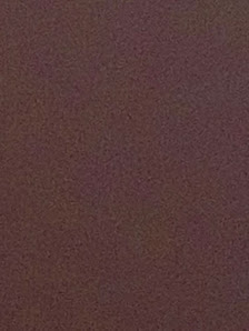 The image shows a plain wall in what appears to be an interior space.