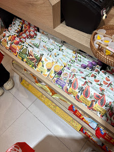 The image depicts an interior view of a retail space in Thao Dien, Saigon, showcasing shelves stocked with various packaged food items, likely snacks 