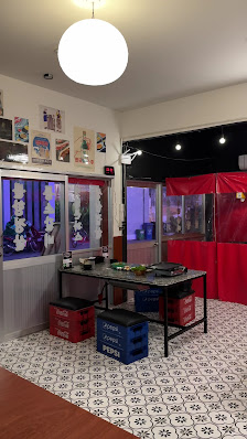 The image shows an indoor setting of a restaurant or cafe in Thao Dien, Saigon. The interior features modern decor with white and black tiled flooring