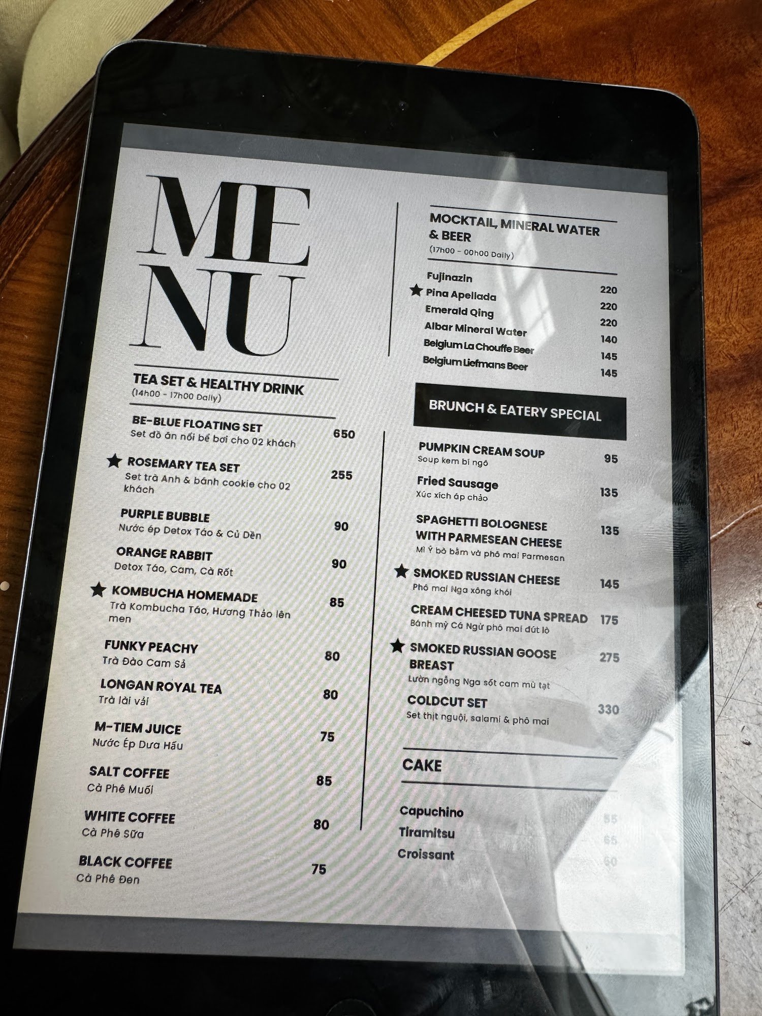 The image displays a digital menu from a venue in Thao Dien, Saigon. It includes sections like 'TEA SET & HEALTHY DRINK', 'MOCKTAIL, MINERAL WATER & B