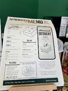 A menu from a place called 'La Focacceria' is displayed on what appears to be a table or counter in Thao Dien, Saigon.