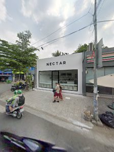The image shows an exterior view of a storefront named 'NECTAR'. It appears to be located on the ground floor with large glass windows and doors, disp