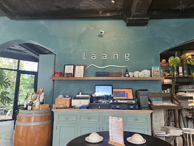 The image depicts the interior of a venue named "laang" in Thao Dien, Saigon. Features include a teal-painted wall with the name "laang" in lowercase 