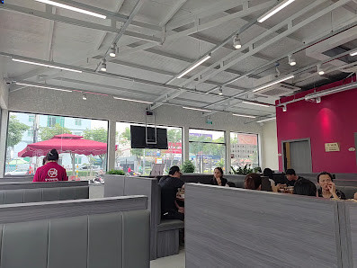 The image shows an interior view of a modern restaurant or cafe located in Thao Dien, Saigon. The space is well-lit with natural light coming through