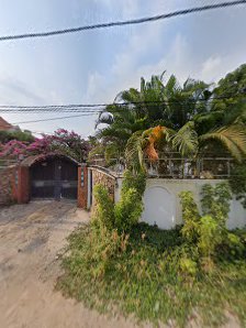 The image shows a residential area in Thao Dien, Saigon. There is a driveway leading to what appears to be an entrance gate with greenery and tropical