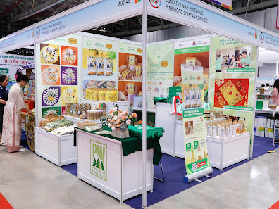 A booth at a trade show or exhibition featuring various products on display for sale.