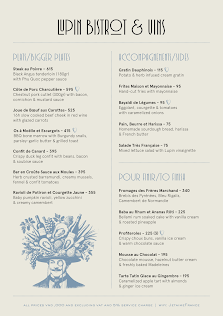 A menu from a venue in Thao Dien, Saigon featuring French cuisine and beverages with prices listed.