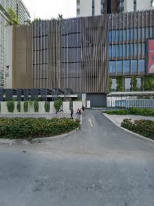 The image depicts a modern commercial building in Thao Dien, Saigon. The building features a facade with vertical slats and large glass windows. In fr