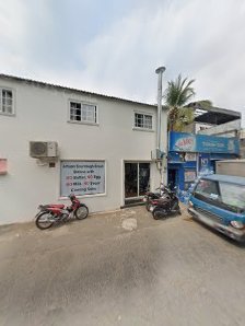 The image shows an exterior view of a two-story building in Thao Dien, Saigon with various establishments on the ground floor and upper level.