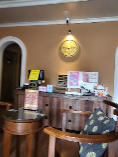 The image shows an interior setting of a venue in Thao Dien, Saigon with wooden furniture and decor elements such as a round table, chairs, and a coun