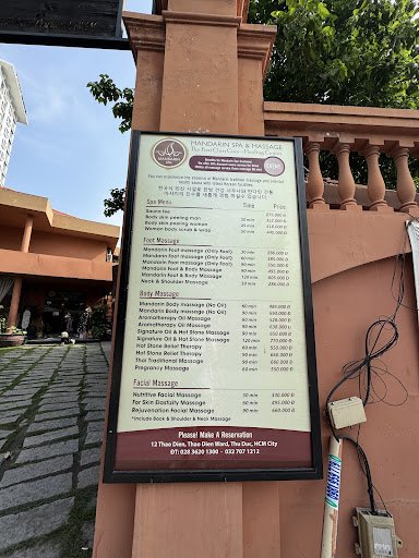 A menu board for a spa and massage establishment named 'HANDBAR SPA & MASSAGE' is displayed on an exterior wall with clear pricing details listed in b