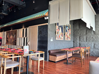The image depicts the interior of a restaurant in Thao Dien, Saigon. It features wooden tables and chairs with red tablecloths, a long wooden bench se