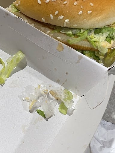 A partially eaten sandwich in a white cardboard box is visible from Thao Dien, Saigon.
