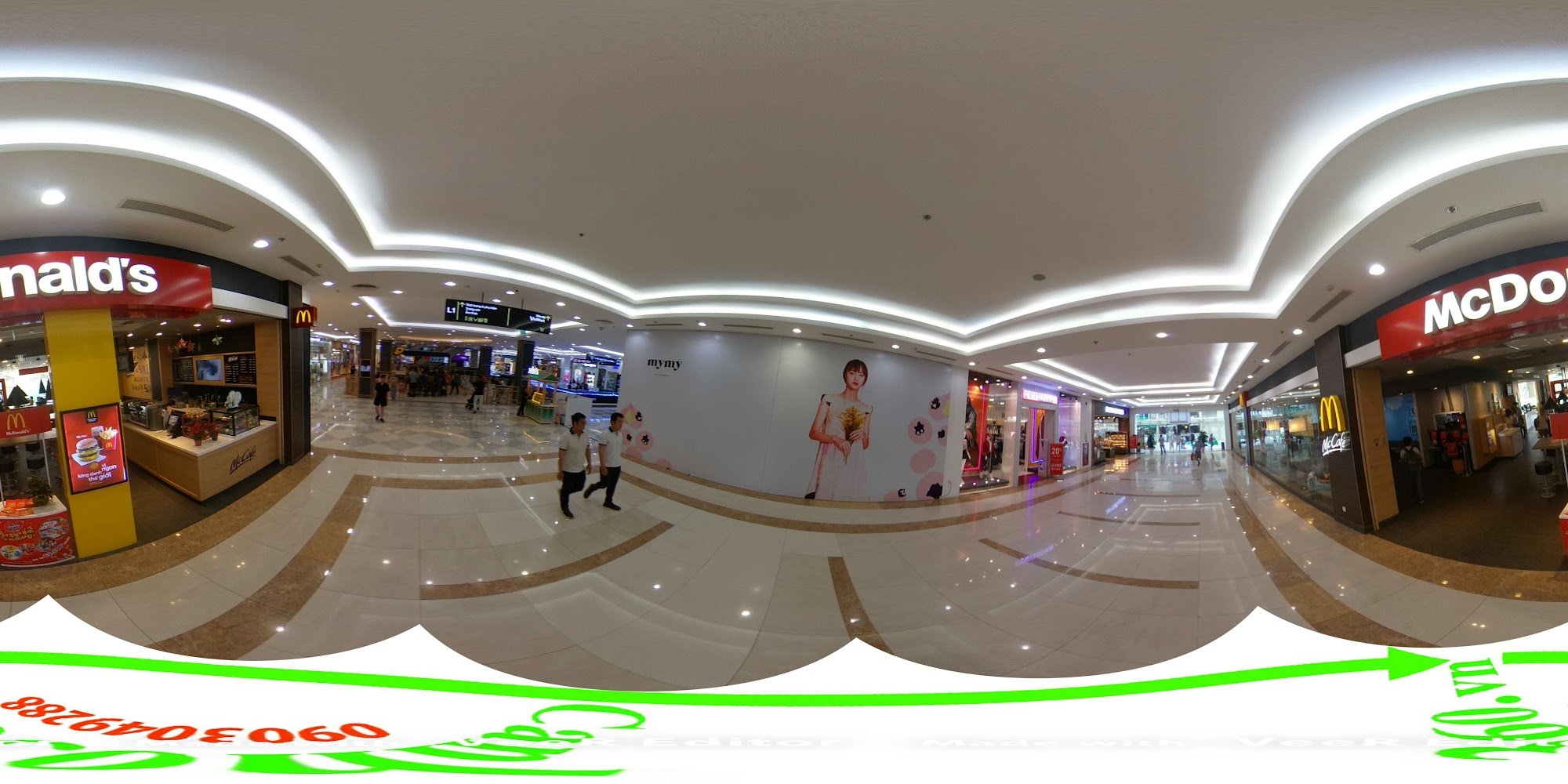A panoramic view of a modern shopping mall interior in Thao Dien, Saigon. The space features polished marble flooring with brown and white patterns, c