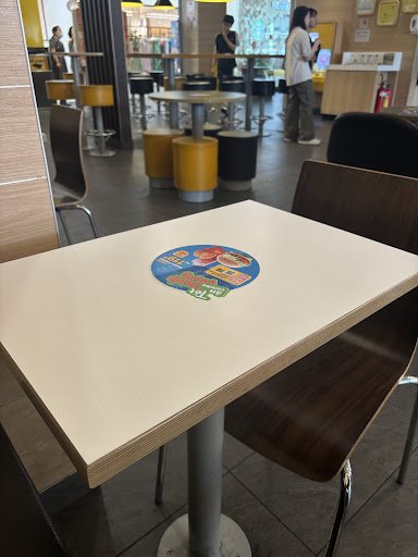 The image shows a section of an interior space that appears to be part of a fast-food restaurant or casual dining establishment, with modern and clean