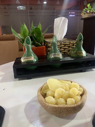 The image shows a part of an interior setting that appears to be a dining area or lounge within Thao Dien, Saigon. On the table is a display with thre