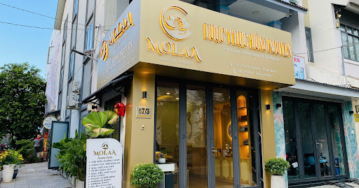 The image shows an exterior view of a restaurant named 'MOLAA', which appears to be located in Thao Dien, Saigon.