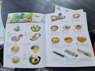 The image displays an open menu from a venue in Thao Dien, Saigon, showcasing vegetarian dishes. The left page features a header 'VEGETARIAN' with ima