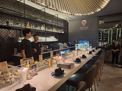 The image depicts an interior view of a modern bar or restaurant setting in Thao Dien, Saigon. The space features contemporary design elements such as