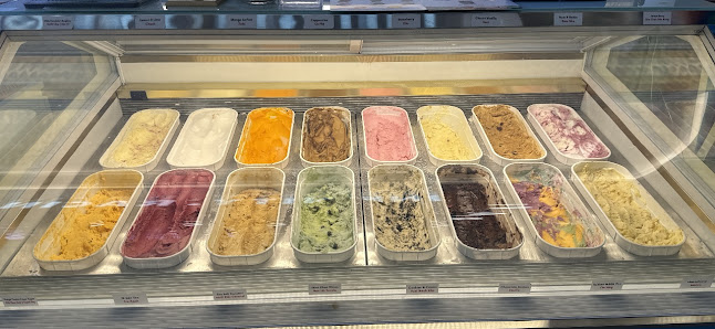 A display case in a venue showcasing an assortment of ice creams and sorbets.