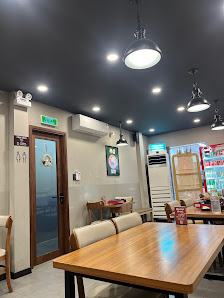 The image shows an indoor setting of a casual dining establishment in Thao Dien, Saigon. The space features modern decor with wooden tables and chairs