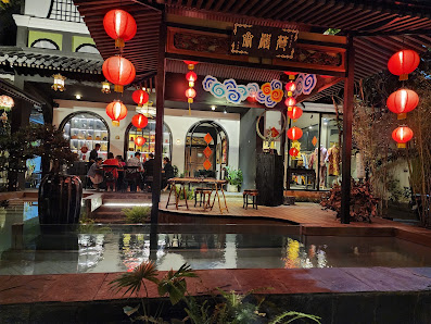 The image depicts an exterior view of a traditional Asian restaurant named 'Thao Dien', which features red lanterns and festive decorations, including