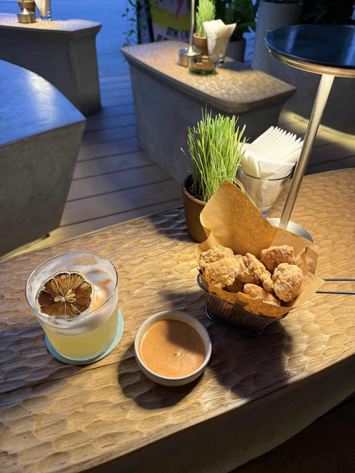 This image depicts a stylish interior setting of what appears to be an upscale bar or restaurant in Thao Dien, Saigon. The focus is on the counter are