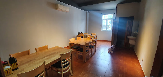 The image shows an interior space that appears to be a dining area within a residential or small commercial building. The room has wooden flooring and