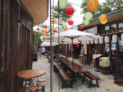 The image depicts an outdoor seating area of a restaurant or café in Thao Dien, Saigon. The venue is adorned with colorful paper lanterns hanging from
