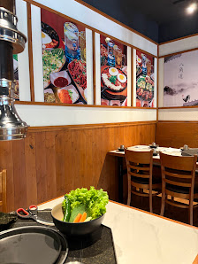 The image depicts the interior of a restaurant in Thao Dien, Saigon. Features include wooden paneling on the lower walls, a white countertop with a bo