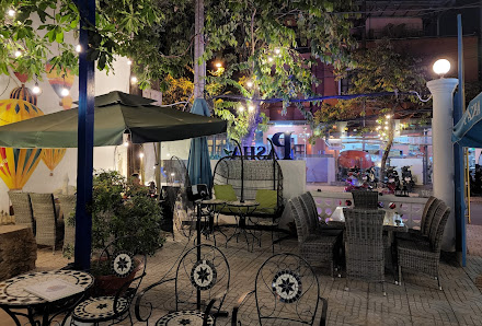 The image depicts an outdoor seating area of a restaurant or café at night in Thao Dien, Saigon.